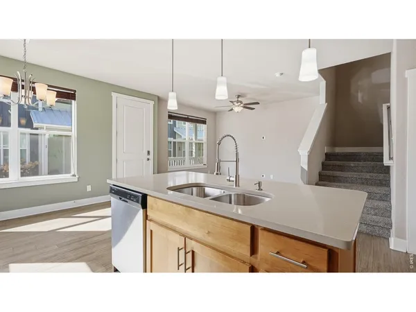 a kitchen with a sink a table and chairs