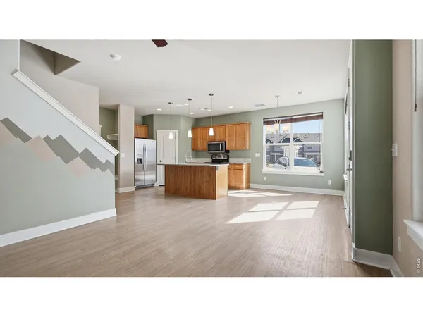 a living room with furniture and a kitchen