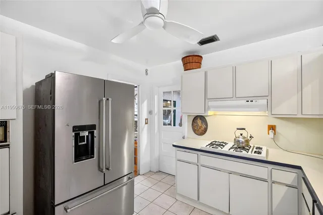 a kitchen with a refrigerator and cabinets