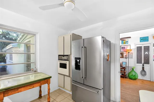 a kitchen with stainless steel appliances a refrigerator and wooden floor