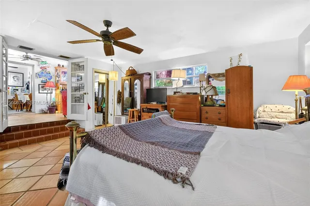 a bed room with a bed and a ceiling fan