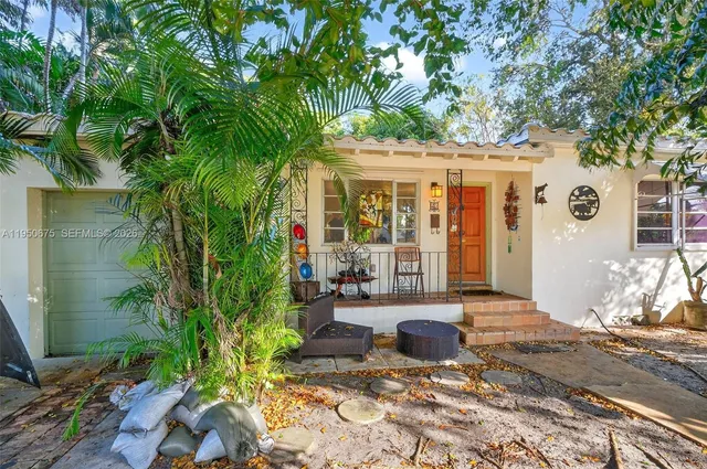 a front view of a house with garden