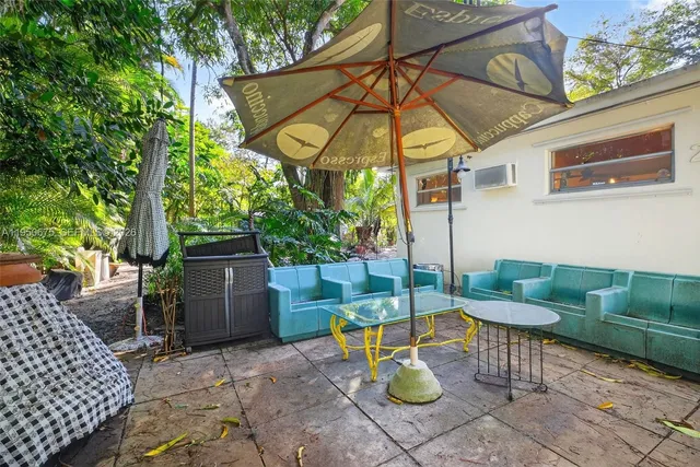 a view of an outdoor sitting area with chairs and fire pit
