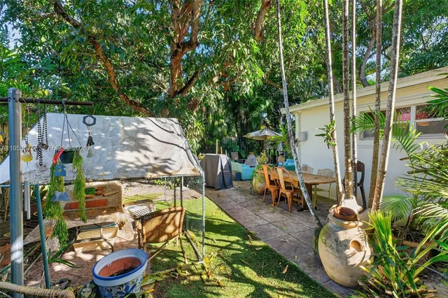 a couple of palm trees sitting in a yard