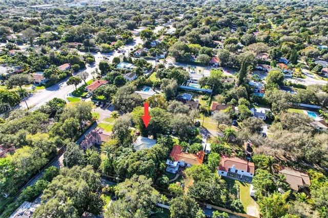 an aerial view of a house with a yard and garden