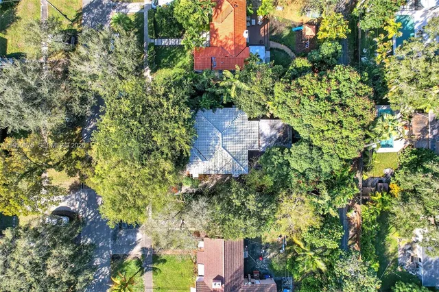 a patio with a table and chairs under an umbrella