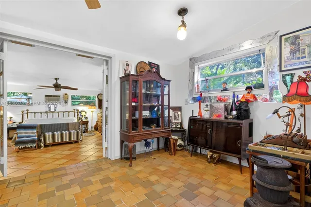 a view of a backyard with large trees and wooden fence