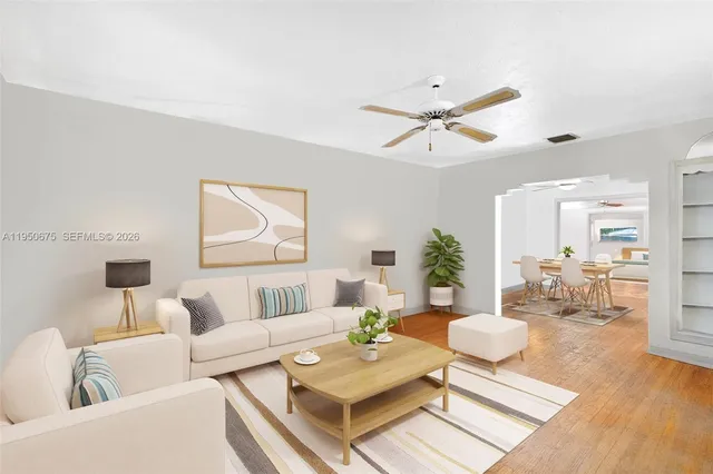 a living room with furniture and wooden floor