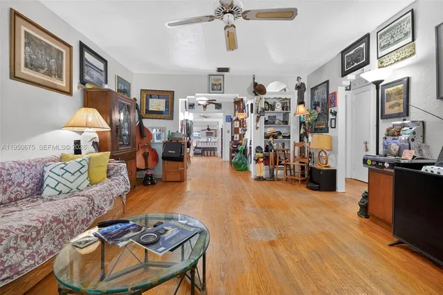 a living room with furniture and wooden floor