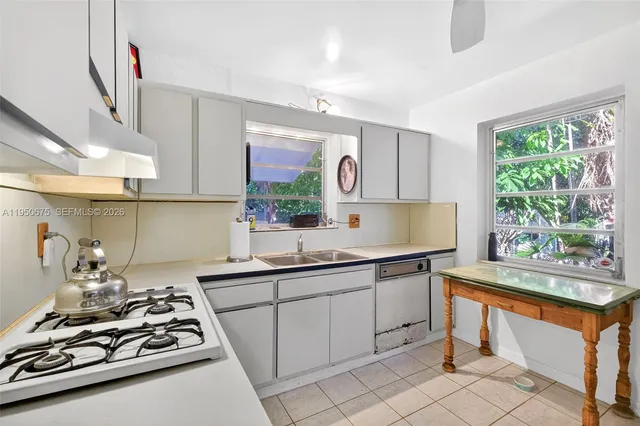 a kitchen with a sink stove and cabinets