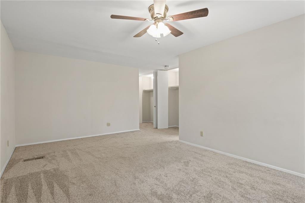 705 Edgewater Trail Sandy Springs, GA 30328 - Photo 22 of 36 an empty room with closet and a chandelier fan