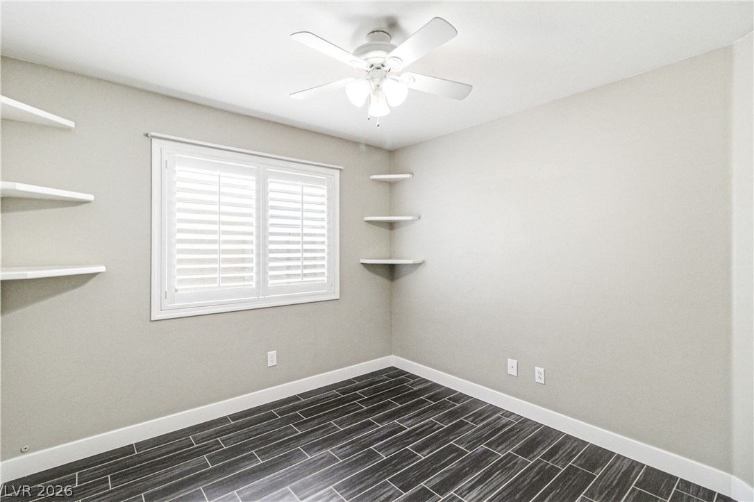 9523 Observer Street Las Vegas, NV 89123 - Photo 24 of 42 Well-lit room featuring practical built-in shelves and sleek tile flooring.
