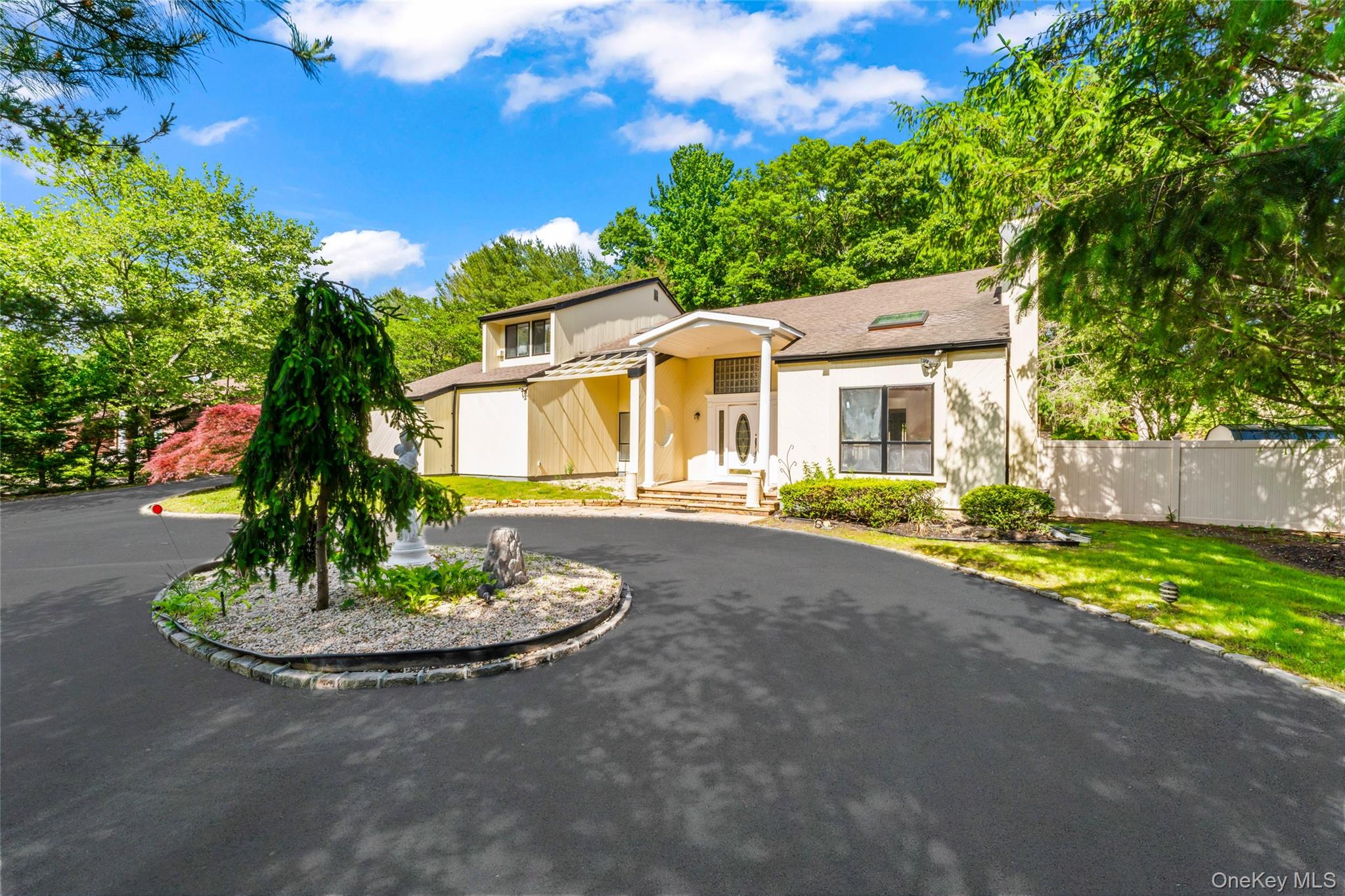 126 Bagatelle Road Melville, NY 11747 - Photo 48 of 50 a front view of a house with a yard and trees