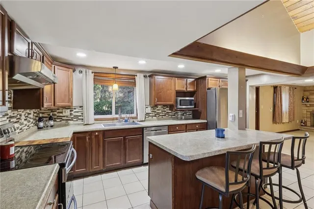 a kitchen with a table chairs sink and cabinets