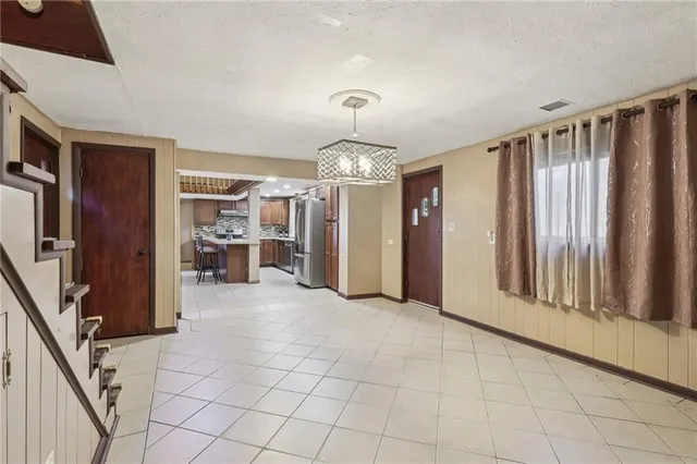 a view of a livingroom with an empty space and a window