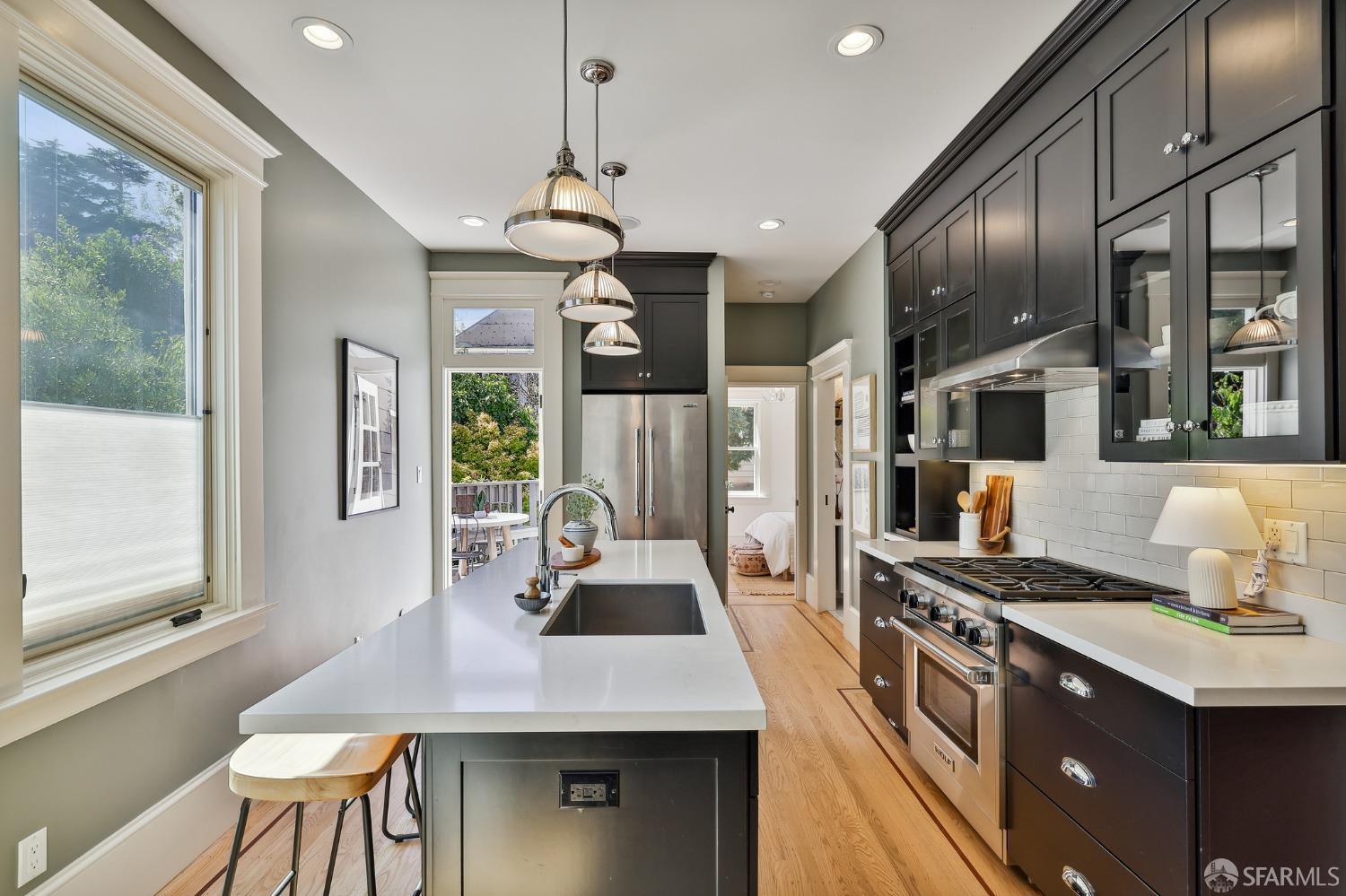 216 Ellsworth Street San Francisco, CA 94110 - Photo 13 of 76 a kitchen with stainless steel appliances a sink a stove and a refrigerator