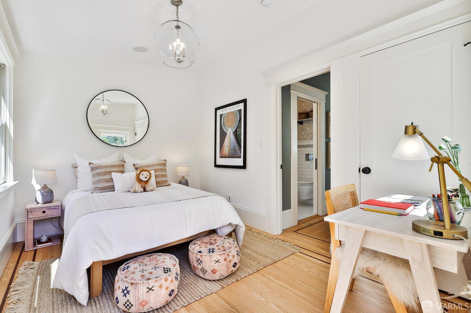 216 Ellsworth Street San Francisco, CA 94110 - Photo 14 of 76 a bedroom with bed and a chandelier