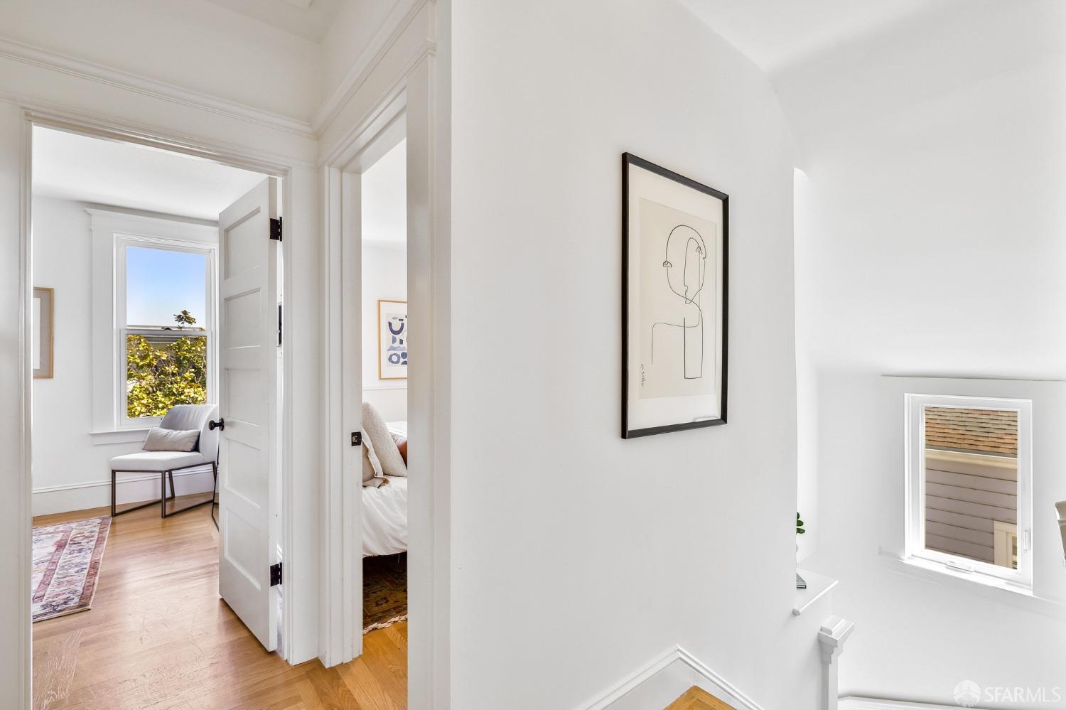 216 Ellsworth Street San Francisco, CA 94110 - Photo 18 of 76 a view of a hallway with wooden floor and a living room