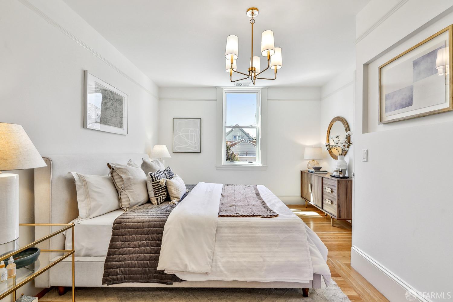 216 Ellsworth Street San Francisco, CA 94110 - Photo 19 of 76 a bedroom with bed and wooden floor