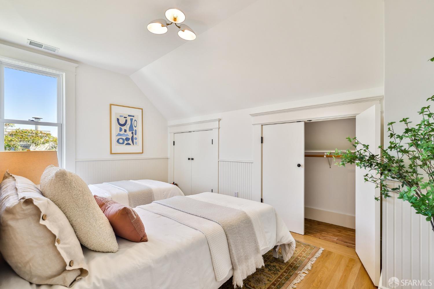 216 Ellsworth Street San Francisco, CA 94110 - Photo 23 of 76 a bedroom with a bed and a potted plant