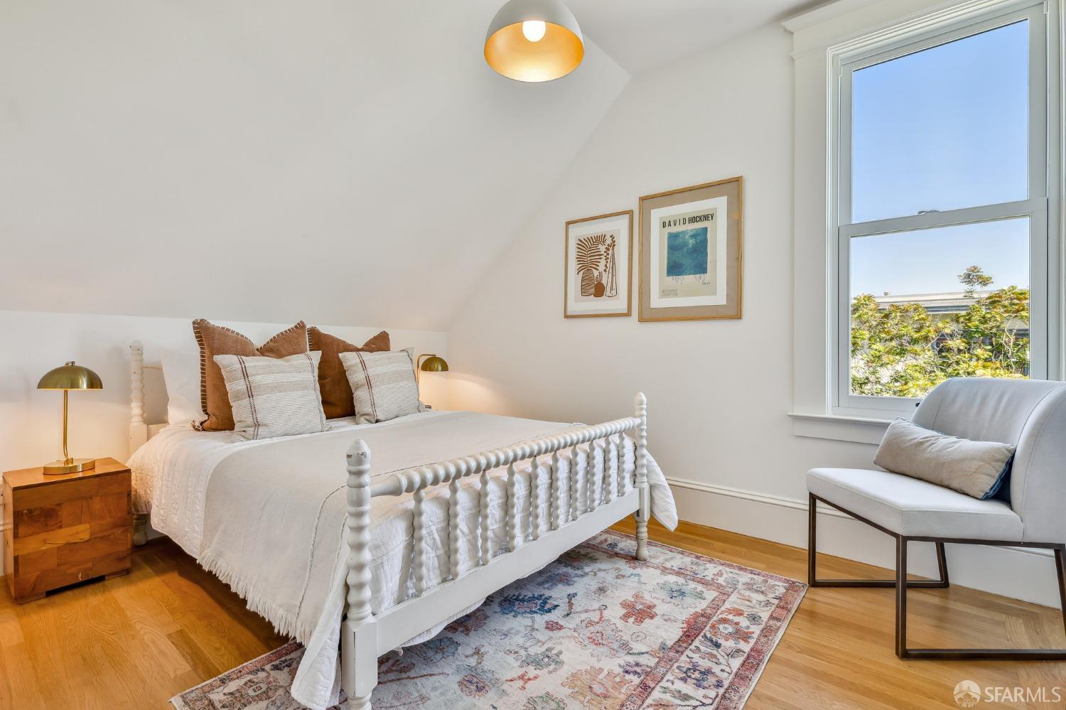 216 Ellsworth Street San Francisco, CA 94110 - Photo 26 of 76 a bedroom with a bed and a window