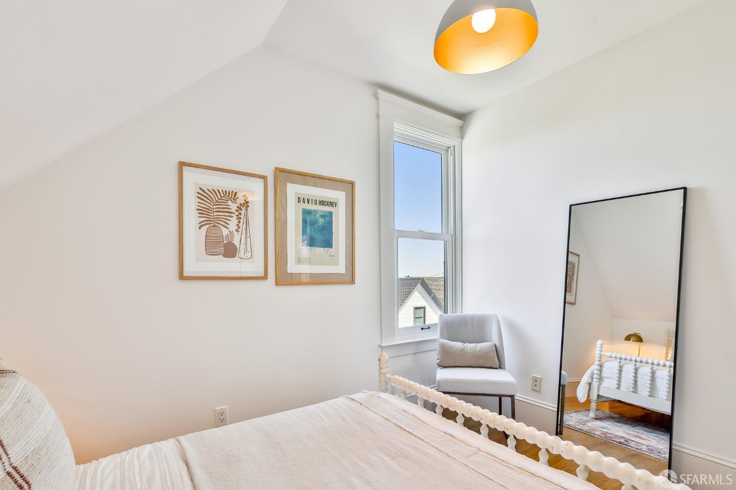 216 Ellsworth Street San Francisco, CA 94110 - Photo 27 of 76 a bedroom with a bed and furniture