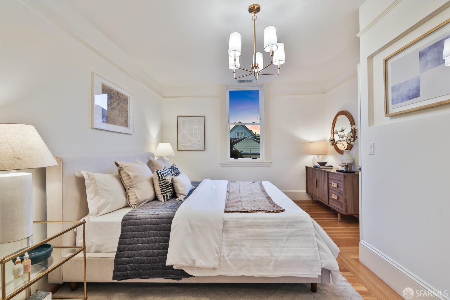 216 Ellsworth Street San Francisco, CA 94110 - Photo 48 of 76 a bedroom with a bed and wooden floor