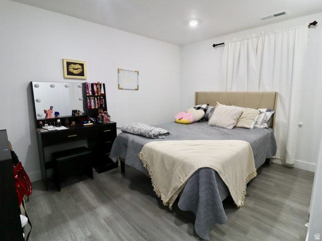 8240 Cascade Vw Way Magna, UT 84044 - Photo 17 of 18 Bedroom featuring wood finished floors and baseboards