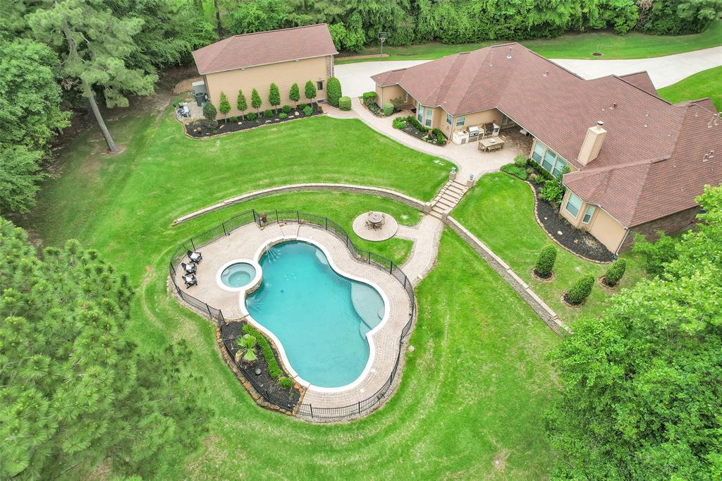 an aerial view of a house with outdoor space and swimming pool