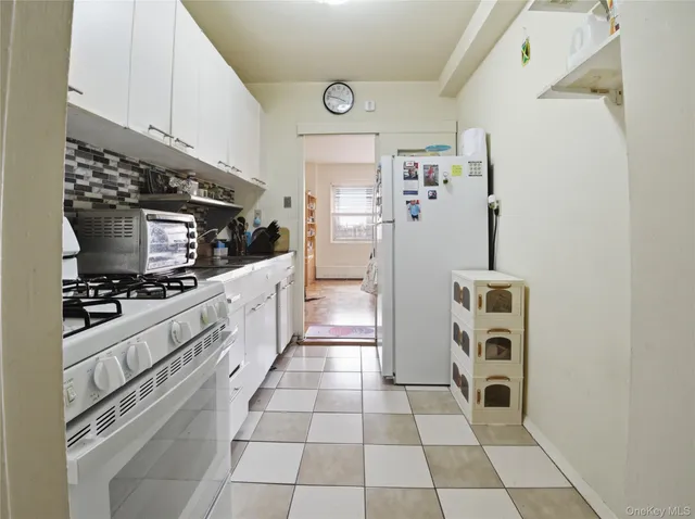 a kitchen with stainless steel appliances a refrigerator and a stove top oven