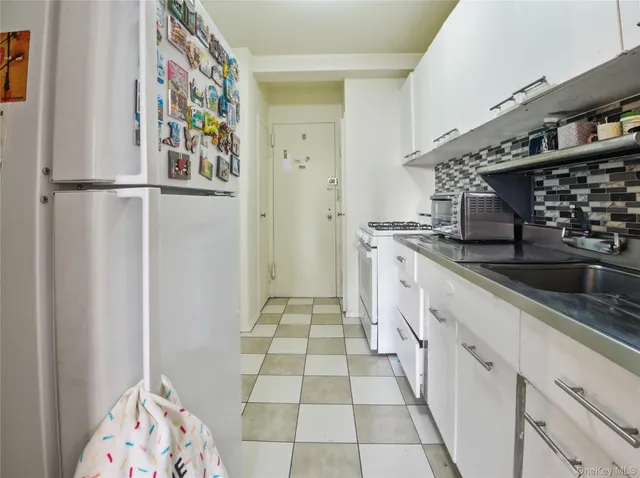 a kitchen with stainless steel appliances granite countertop a sink and a stove top oven