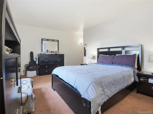 a bedroom with a bed and dresser