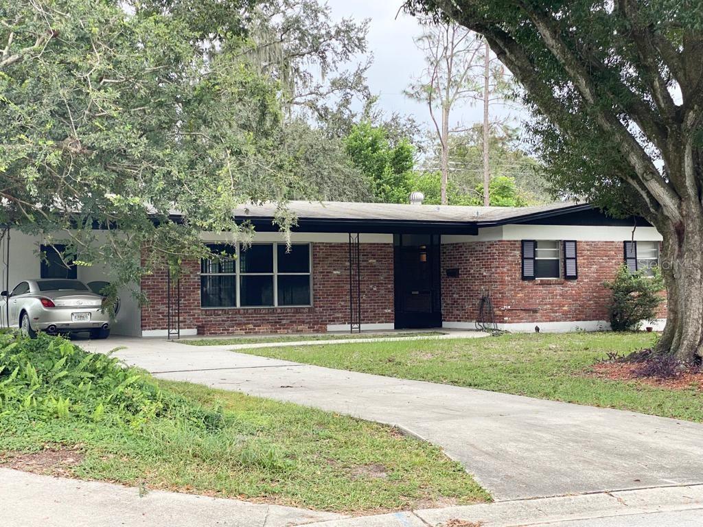 929 Skyview Drive Brandon, FL 33510 - Photo 1 of 1 a front view of a house with a garden and trees