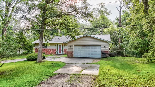 a front view of house with yard and trees