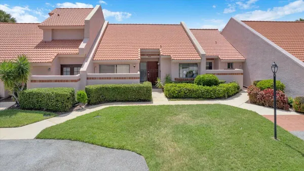 a front view of a house with a garden