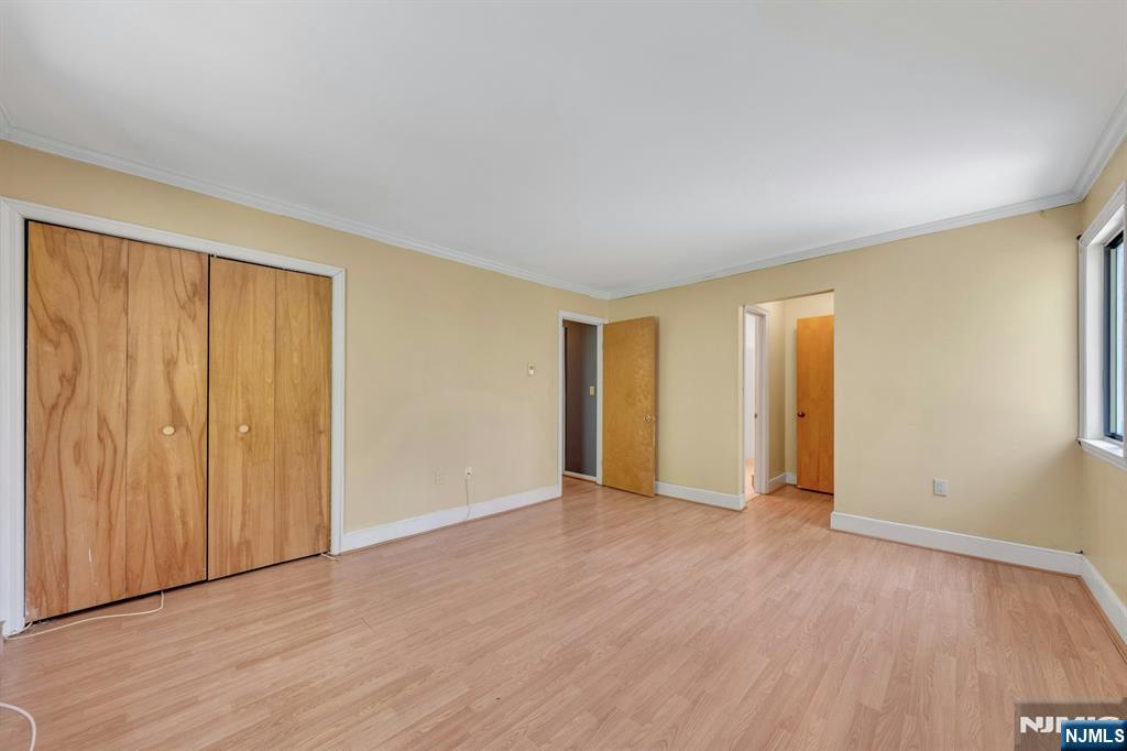666 Mill Street, Unit C6 Belleville, NJ 07109 - Photo 13 of 25 an empty room with wooden floor and closet area