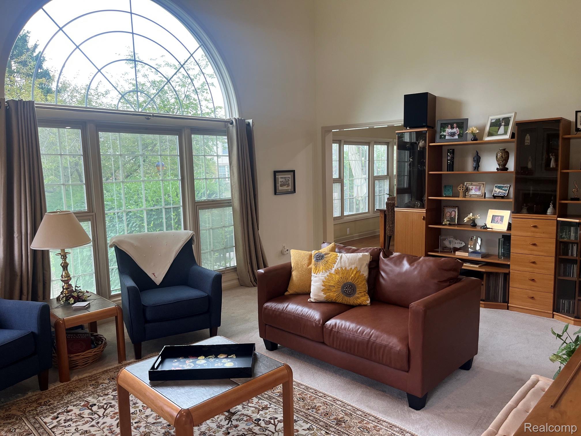 1708 Devonwood Drive Rochester, MI 48306 - Photo 70 of 70 Vaulted ceiling with an arched window above a Multi-pane window assembly, newer beige carpeting, second stairway to upper level.