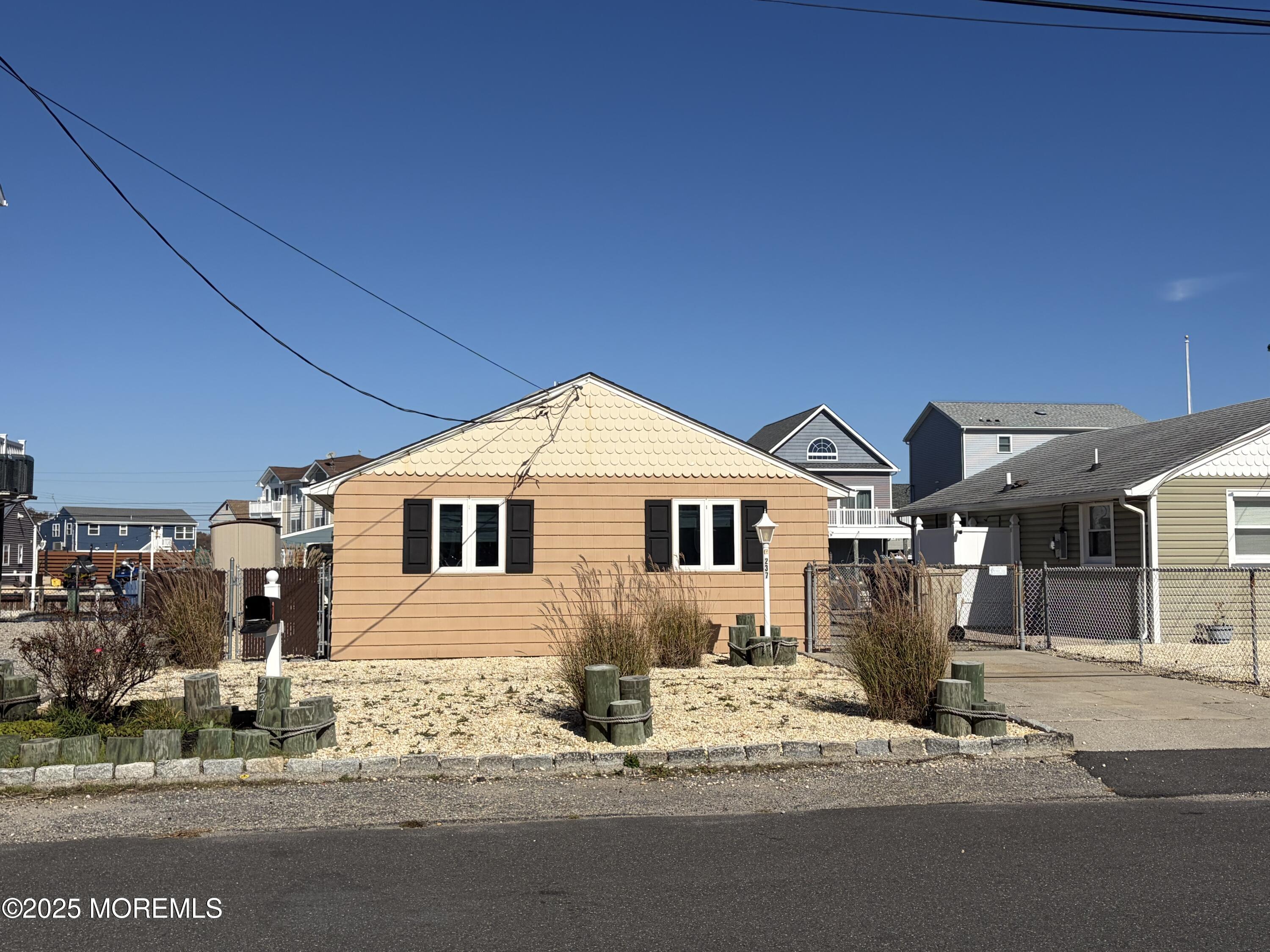 237 Butler Boulevard Bayville, NJ 08721 - Photo 15 of 25 a view of a house with a patio