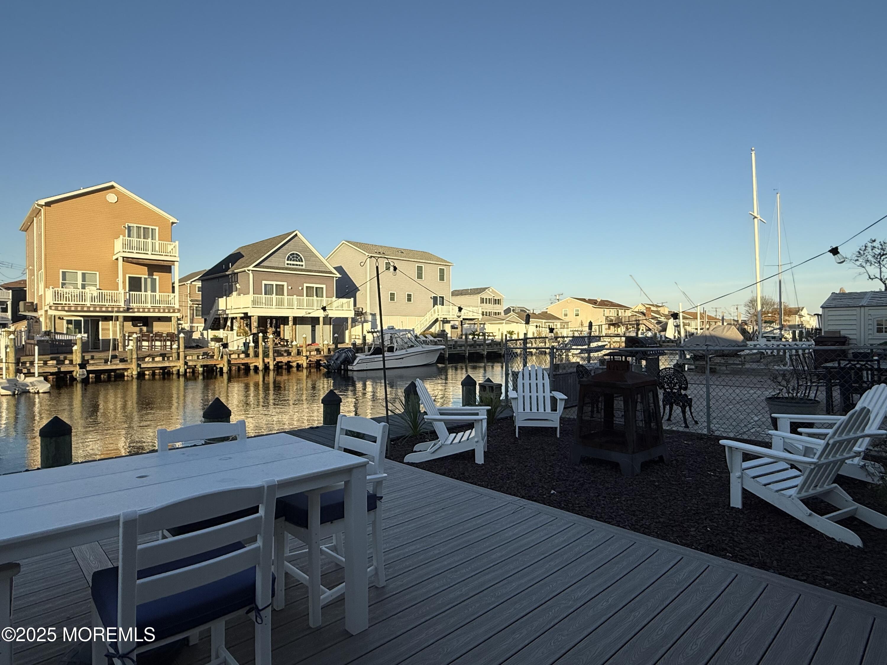 237 Butler Boulevard Bayville, NJ 08721 - Photo 17 of 25 a view of a rooftop deck with dining table and chairs