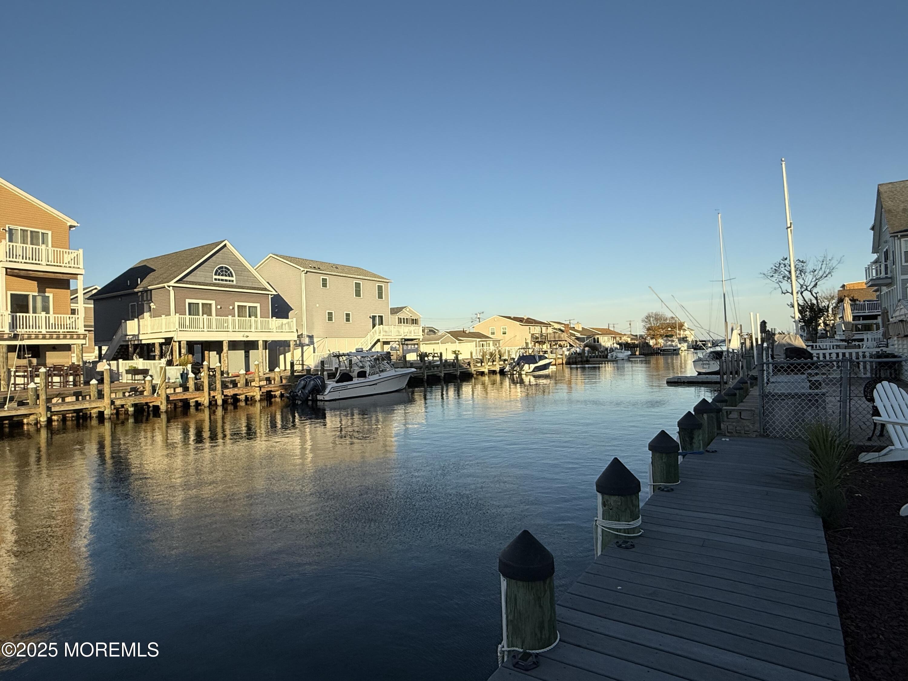 237 Butler Boulevard Bayville, NJ 08721 - Photo 19 of 25 a view of a lake with boats and trees in the background