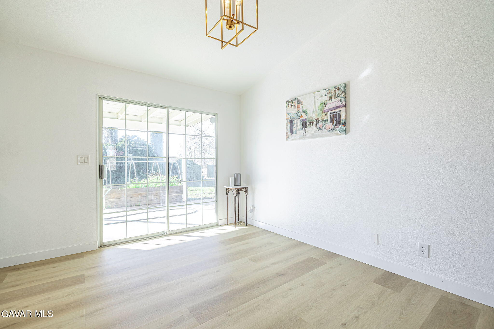 7930 Elder Avenue Rosamond, CA 93560 - Photo 20 of 35 an empty room with wooden floor and windows