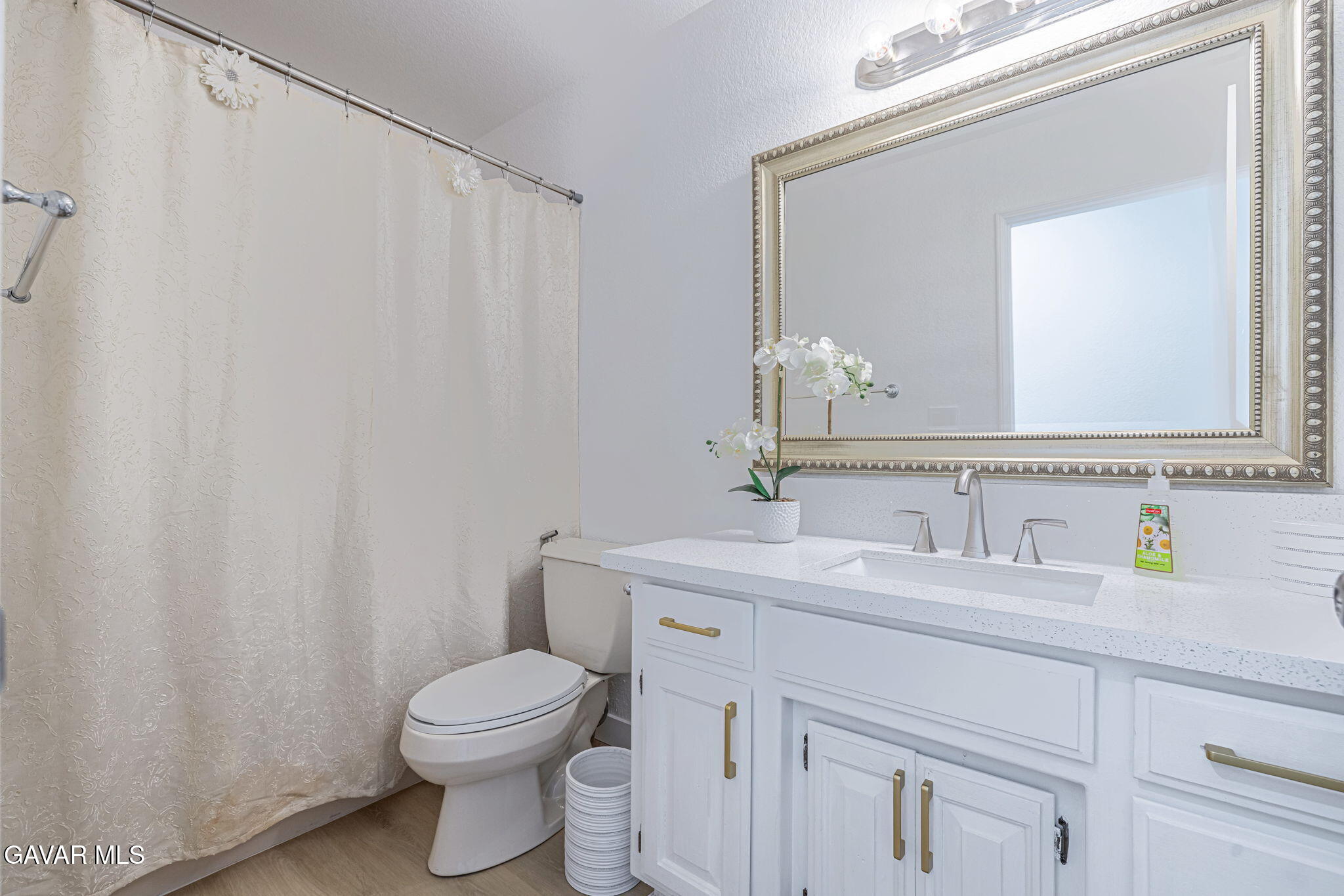 7930 Elder Avenue Rosamond, CA 93560 - Photo 25 of 35 a bathroom with a toilet a sink a vanity and mirror