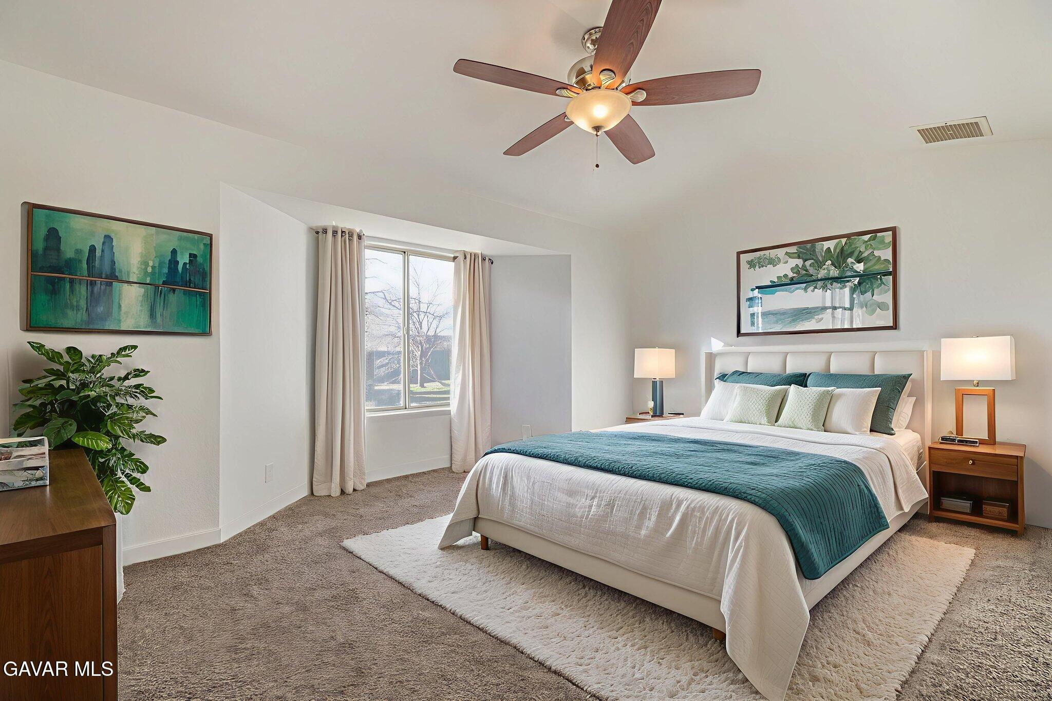 7930 Elder Avenue Rosamond, CA 93560 - Photo 5 of 35 a bedroom with a large bed and a window