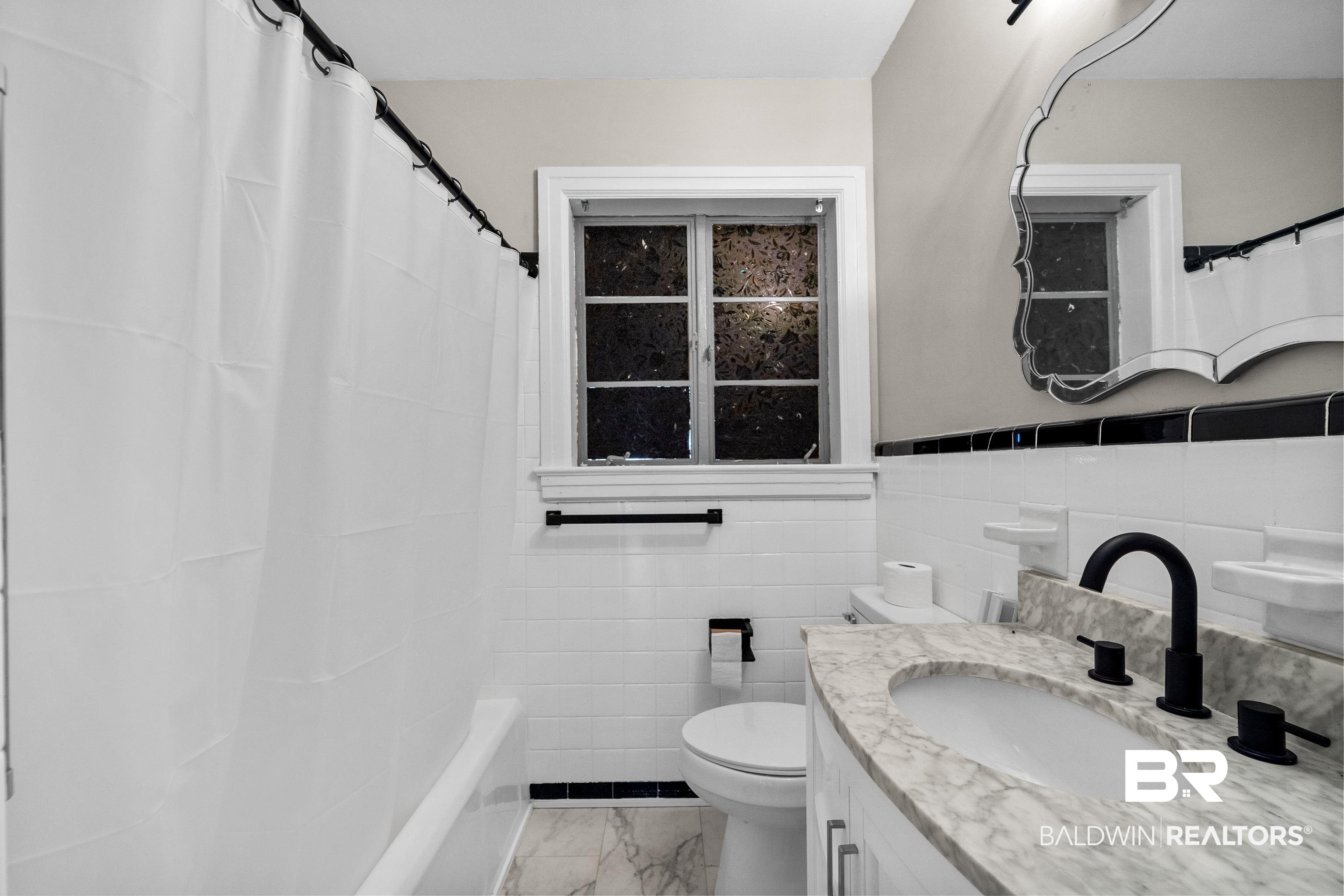 611 Morgan Avenue Mobile, AL 36606 - Photo 20 of 24 Full bathroom featuring vanity, toilet, tile walls, and shower / bath combo