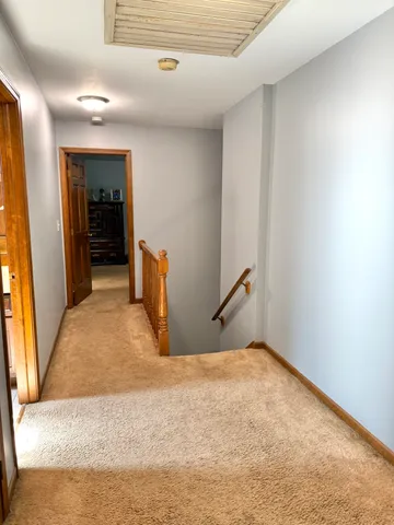 a view of a livingroom with wooden floor and a window