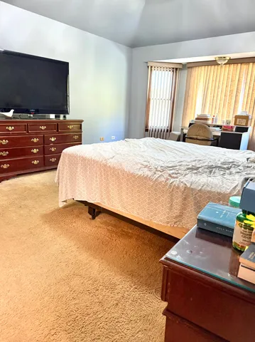 a bedroom with a bed and flat screen tv