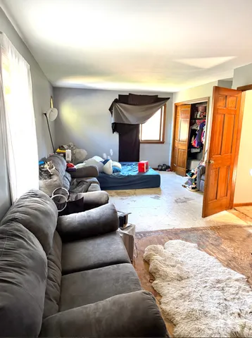 a living room with furniture a window and a flat screen tv