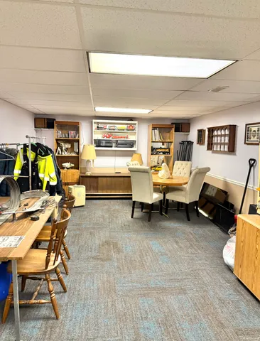 a living room with furniture and gym equipment