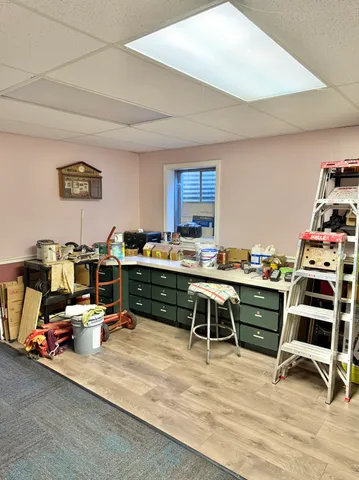 a view of a workspace with furniture and a window