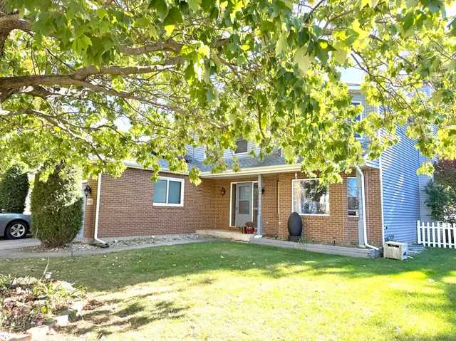 a backyard of a house with table and chairs